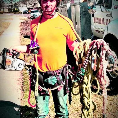 man holding tree climbing equipment