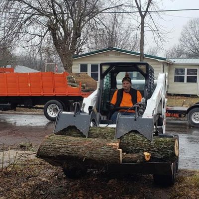 man moving stumps tree removal