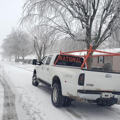 truck in the snow before tree removal service